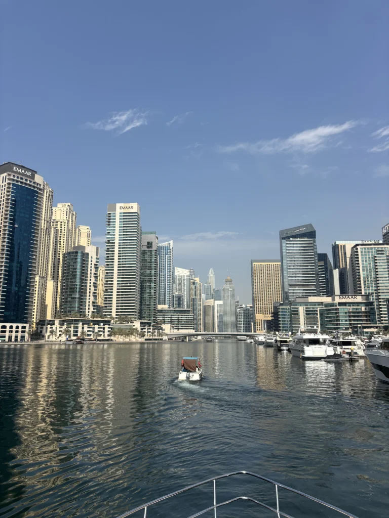 Private yacht cruising past the Dubai Marina skyline